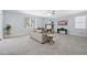 Spacious living room featuring neutral tones, a ceiling fan, and a cozy seating arrangement at 3845 Alden Place, Cumming, GA 30028