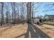 A lovely backyard with lush grass, mature trees, and a charming storage shed at 403 Flint Hill Ct, Lawrenceville, GA 30044