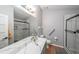 Bathroom featuring a granite-look vanity, glass-enclosed shower, and brushed nickel hardware at 403 Flint Hill Ct, Lawrenceville, GA 30044