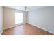 Spare bedroom with neutral walls, wood-look floors, and window for natural light at 403 Flint Hill Ct, Lawrenceville, GA 30044