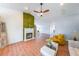 Bright living room featuring a fireplace, ceiling fan, and hardwood floors at 403 Flint Hill Ct, Lawrenceville, GA 30044