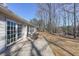 Covered patio features outdoor seating and overlooks a large, tree-filled backyard at 403 Flint Hill Ct, Lawrenceville, GA 30044