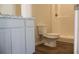Bathroom featuring white cabinets, a toilet, and a shower with white walls at 625 Egrets Landing #49, Covington, GA 30014