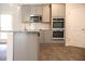 Kitchen with gray cabinets, granite countertops, stainless steel appliances and wood-look flooring at 625 Egrets Landing #49, Covington, GA 30014