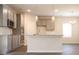 Open kitchen features gray cabinets, stainless steel appliances, and a granite countertop island at 625 Egrets Landing #49, Covington, GA 30014