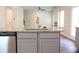 Kitchen island featuring gray cabinets, stainless steel appliances, and granite countertops at 625 Egrets Landing #49, Covington, GA 30014
