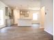 Open-concept living room with gray kitchen cabinets, stainless steel appliances, and a center island at 625 Egrets Landing #49, Covington, GA 30014