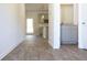 Open-concept living room with light gray walls, wood-look flooring, and neutral color palette at 625 Egrets Landing #49, Covington, GA 30014