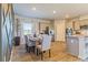 A well lit dining area shows off the dining table and the kitchen at 625 Egrets Landing Lndg, Covington, GA 30014