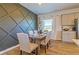 Bright dining area with modern wall art and a view of the lush, green outdoors at 625 Egrets Landing #49, Covington, GA 30014