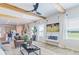 Inviting living room with wood beams, fireplace, modern entertainment setup, and a view into the kitchen at 625 Egrets Landing Lndg, Covington, GA 30014