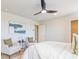 Bright main bedroom featuring two chairs, ceiling fan, and white walls at 625 Egrets Landing #49, Covington, GA 30014