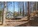 The spacious backyard features green grass, a storage shed, and a trampoline at 3540 Traddsprings Way, Snellville, GA 30039