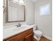 Powder room with wood vanity, white countertops, modern faucet and a decorative framed mirror with a frosted window at 4358 Stockton Way, Marietta, GA 30066