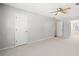 Bedroom featuring neutral carpet, gray walls, ceiling fan and access to a full bathroom at 4358 Stockton Way, Marietta, GA 30066