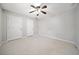 Bedroom with neutral walls, ceiling fan, and carpeted floors with double doors at 4358 Stockton Way, Marietta, GA 30066