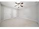 Bedroom with neutral carpet, ceiling fan, and ample closet space at 4358 Stockton Way, Marietta, GA 30066