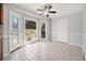 Bright breakfast nook features large windows, a door to backyard, tile floors and modern ceiling fan at 4358 Stockton Way, Marietta, GA 30066