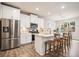 Modern kitchen features stainless steel appliances, white cabinetry, and a center island with bar seating at 126 Maple Creek Way, Woodstock, GA 30188