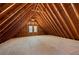 Spacious unfinished attic with wood beams, two windows for natural light, and plywood flooring at 2242 Longford Ne Ct, Marietta, GA 30066