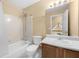 Hall bathroom with a tub and shower, toilet, vanity, and framed mirror at 2242 Longford Ne Ct, Marietta, GA 30066