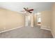 Spacious bedroom with a ceiling fan, neutral carpet, and access to an ensuite bathroom and walk-in closet at 2242 Longford Ne Ct, Marietta, GA 30066