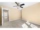 Bedroom featuring neutral carpet, a ceiling fan, and a view into the hallway at 2242 Longford Ne Ct, Marietta, GA 30066