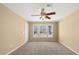 Bedroom featuring a ceiling fan, neutral carpet, and three large windows offering plenty of natural light at 2242 Longford Ne Ct, Marietta, GA 30066