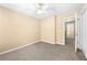 Bedroom featuring neutral carpet, a ceiling fan, and a view into the hallway at 2242 Longford Ne Ct, Marietta, GA 30066