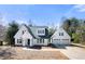 Charming two-story home with white siding, black trim, and an attached two-car garage at 2242 Longford Ne Ct, Marietta, GA 30066