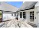 Back patio with white siding, black trim, and multiple access doors at 2242 Longford Ne Ct, Marietta, GA 30066