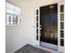 Front door is black with glass sidelights and brass hardware at 2242 Longford Ne Ct, Marietta, GA 30066