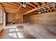 Unfinished garage features high ceilings, natural wood beams, concrete floors, and ample space at 2242 Longford Ne Ct, Marietta, GA 30066