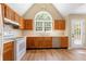 Bright kitchen featuring wooden cabinets, stainless steel appliances, and a large arched window overlooking the backyard at 2242 Longford Ne Ct, Marietta, GA 30066