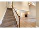 Carpeted staircase with a wood railing leading to a spacious living area with a fireplace at 2242 Longford Ne Ct, Marietta, GA 30066