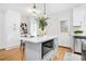 Bright kitchen with stainless steel appliances, an island with a microwave, and white subway tile backsplash at 2874 Horse Shoe Dr, Atlanta, GA 30316