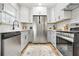 This kitchen features stainless steel appliances, white cabinets, quartz countertops, and a subway tile backsplash at 2874 Horse Shoe Dr, Atlanta, GA 30316