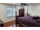 Bedroom featuring a four-poster bed, dresser, and large window with blinds at 3129 Rock Pine Way, Snellville, GA 30078
