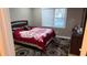 Bedroom features a bed with a rose patterned comforter, large windows, and a patterned rug at 3129 Rock Pine Way, Snellville, GA 30078