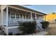 Charming home featuring a covered front porch with white railings and front shrubs at 3129 Rock Pine Way, Snellville, GA 30078