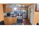 A cozy kitchen featuring wood cabinets, stainless steel appliances, and a dark countertop with a dining area at 3129 Rock Pine Way, Snellville, GA 30078