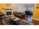 Inviting living room featuring stone fireplace, hardwood floors, and a comfortable seating area at 3129 Rock Pine Way, Snellville, GA 30078