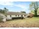Backyard with a brick house, grassy area, and privacy hedge at 2107 Old Dallas Sw Rd, Marietta, GA 30064