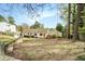 Backyard with a brick home, level lawn, mature trees, and established landscaping at 2107 Old Dallas Sw Rd, Marietta, GA 30064