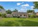 Spacious backyard offers a large grassy area, lush greenery, and a classic exterior, creating a serene outdoor retreat at 2107 Old Dallas Sw Rd, Marietta, GA 30064