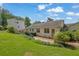 Expansive backyard featuring a well-maintained lawn, mature trees, and a brick patio, perfect for outdoor enjoyment at 2107 Old Dallas Sw Rd, Marietta, GA 30064