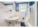 Classic bathroom with white tiling, a pedestal sink, and a shower/tub combination at 2107 Old Dallas Sw Rd, Marietta, GA 30064