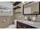 Cozy bathroom with floating shelves, a large mirror, toilet and dark wood vanity at 2107 Old Dallas Sw Rd, Marietta, GA 30064