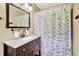 Bathroom featuring a shower-tub combo with decorative shower curtain, and a dark wood vanity at 2107 Old Dallas Sw Rd, Marietta, GA 30064