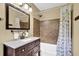 Bathroom featuring a shower-tub combo with decorative shower curtain, and a dark wood vanity at 2107 Old Dallas Sw Rd, Marietta, GA 30064